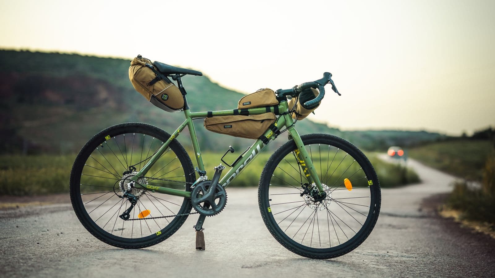 Vélo de voyage chargé, arrêté au bord d'une route de campagne